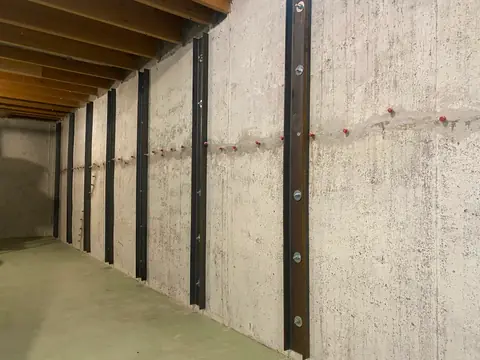 Treated line and repair ports on concrete between vertical steel members